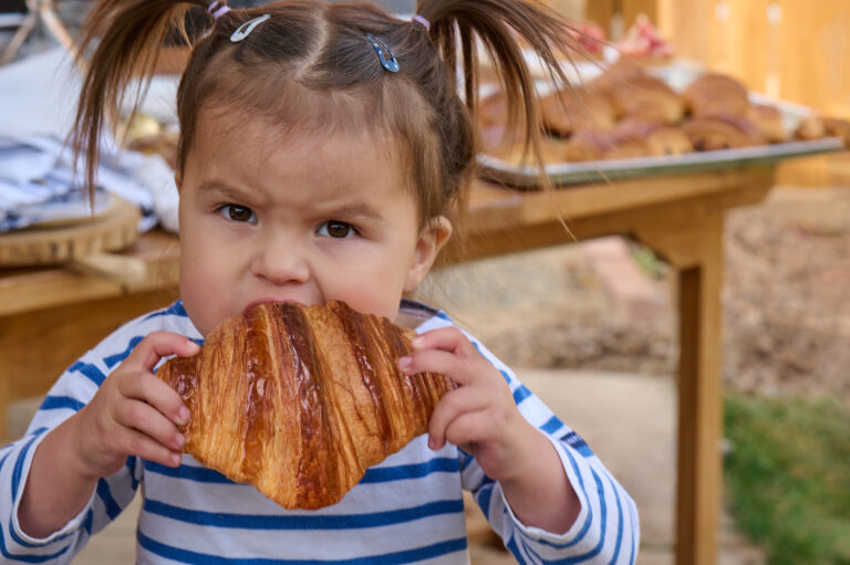 Paloma Eating Croissant - Horizontal